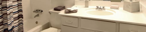 Spacious bright white bathroom at Briarwood Apartments in Houston.