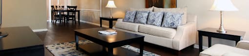 Spacious living room, spacious dining room, spacious townhome with hardwood floors, and private entries at Briarwood Apartments in Houston.