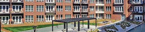 Large courtyard with landscaping, sitting area and grilling area at Xenia Apartments in Golden Valley, Minnesota