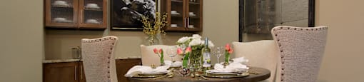 Luxury dining room with built-in buffet with granite slab top, and 10-foot ceilings at Tuscany Walk Apartments in Houston Texas.