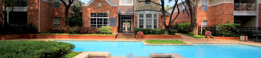 Luxury apartments with two resort-style swimming pools near the Mary Kay Museum with attached garages, golf course views, and beautiful landscaping in Dallas.