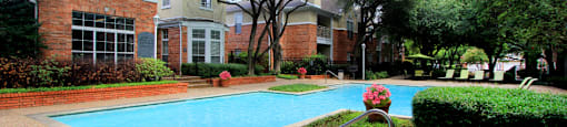 Luxury apartments with two resort-style swimming pools near the Mary Kay Museum with attached garages, golf course views, and beautiful landscaping in Dallas.
