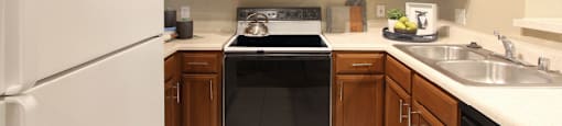 U-shaped kitchen with breakfast bar at The Dorchester Apartments in north Dallas.