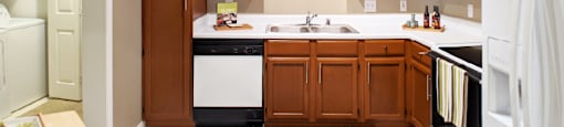 a kitchen with wooden cabinets and white appliances