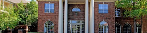 Gated community near the Galleria with brick exteriors, covered parking, and detached garages.