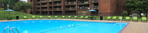 Resort-style saltwater pool with huge sun deck, poolside lounge chairs, huge balconies, and park-like setting with lots of trees and scenic views at Embassy Park Apartments in Omaha, Nebraska