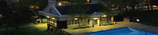 Resort-style saltwater pool with huge sun deck, poolside lounge chairs, and park-like setting with lots of trees and scenic views at Embassy Park Apartments in Omaha, Nebraska