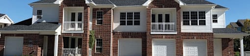 Luxury townhomes with attached garages, scenic views and red brick exteriors at Bellemeade Apartments in west Des Moines