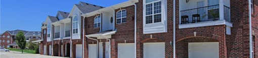 Luxury townhomes with attached garages and red brick exterior next to Rockledge Shopping Center in South Lincoln Nebraska