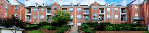 Luxury apartments with red brick exteriors, lush landscaping, landscaped courtyard, and beautiful grounds at TurtleCreek Apartments in West Des Moines