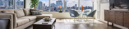 the living room of an apartment with a view of the city
