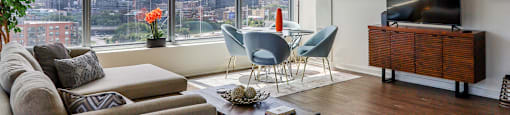a living room with a view of a city and a couch and a table in