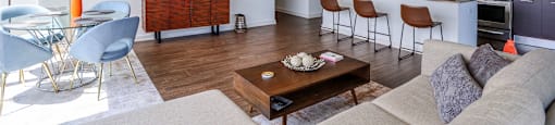 a living room with a couch and a table with chairs