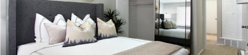 Spacious bedroom with walk-in closet and gray wall color at Inwood Apartments in La Vista, Nebraska
