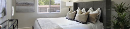 Spacious bedroom with walk-in closet and gray wall color at The Inverness Apartments in La Vista, Nebraska