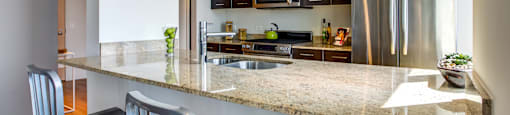 a kitchen with stainless steel appliances and a granite counter top
