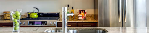 a modern kitchen with stainless steel appliances and granite counter tops