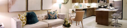 Luxury apartments with spacious open floor plan with built-in wine rack, granite countertops, kitchen island, stainless steel appliances, and designer tile backsplash at Tuscany Walk Apartments in Houston Texas.