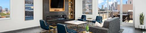 a lounge with a couch and chairs and a television