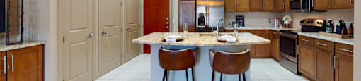 Luxury apartments in Bloomington Minnesota with spacious kitchen, granite countertops, stainless steel appliances, built-in wine rack, kitchen island, and porcelain tile floor at Luxembourg Apartments
