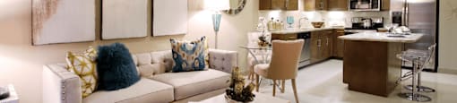 Luxury apartments in Bloomington Minnesota with spacious floor plan, granite countertops, stainless steel appliances, built-in wine rack, kitchen island, and porcelain tile floor at Luxembourg Apartments