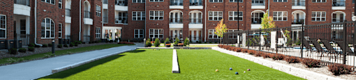 Luxury apartments with bocce ball court, brick exteriors and manicured gardens at Luxembourg Apartments in Bloomington Minnesota