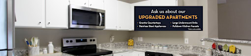 Spacious kitchen with white cabinets, granite countertops, stainless steel appliances, and porcelain tile floors at Breckenridge Apartments in southwest Omaha, Nebraska