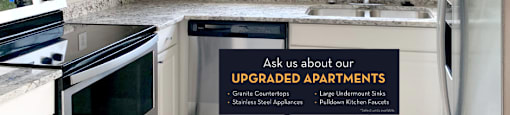 Luxury apartments with granite countertops, white cabinets, stainless steel appliances, and side-by-side refrigerator at TurtleCreek apartments in West Des Moines, Iowa