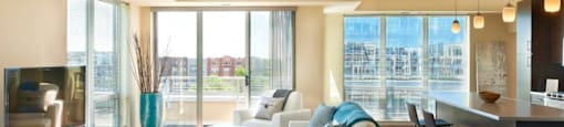 A living room with a white couch and a television.