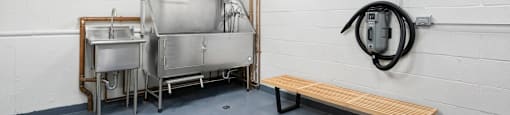 a pet spa sink and a bench in a room