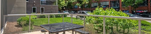 a patio with a table and chairs on a balcony