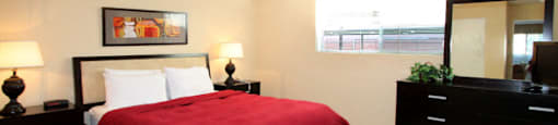 Spacious bedroom with ceiling fan and walk-in closet at Plantation apartments near the Galleria in Houston.