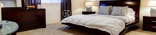 Spacious bedroom with ceiling fan and walk-in closet at Plantation apartments near the Galleria in Houston.