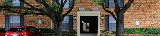 Apartments near the Galleria with brick exteriors, covered parking and courtyard setting at Plantation apartments in Houston.