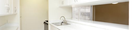 Apartments near the Galleria with bright white kitchens, wood plank floors, and extra cabinet space