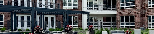 Luxury resort-style swimming pool with poolside cabanas and lounge chairs at Xenia Apartments in Golden Valley Minnesota