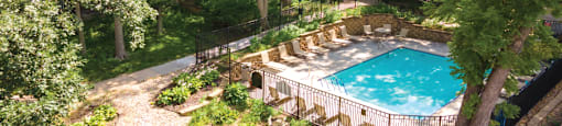 a backyard with a swimming pool and a house with trees
