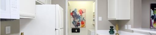 Bright white kitchen, spacious kitchen and full size and washer and dryer at Preston Village Apartments in North Dallas