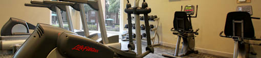 Luxury apartments with a fitness center in a gated community at Preston Village Apartments in North Dallas