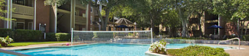 Luxury apartments with beautiful fountains, beautiful landscaping, gazebo, spa, and swimming pool with poolside lounge chairs, grilling station and scenic views at Preston Village Apartments in north Dallas