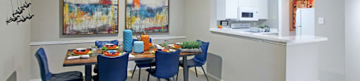 Spacious apartments with dining room and kitchen with white cabinets at Preston Village Apartments in north Dallas
