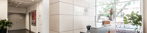an office lobby with a reception desk and a large window