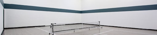 A tennis court with a net and two posts.