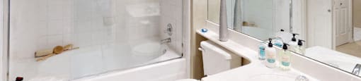 Luxury apartments with spacious bathrooms with glass showers, oval soaking tubs, and cultured marble vanities at Tuscany Gate Apartments in Houston.