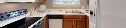 Luxury apartments with spacious kitchens, custom home cabinets, and side-by-side refrigerators at Tuscany Gate Apartments in Houston.