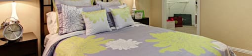 Spacious bedroom with walk-in closet and ceiling fan at Tuscany Oaks Apartments in Houston.