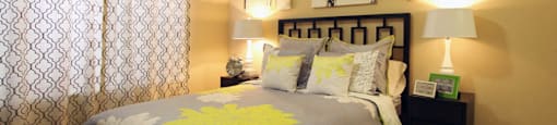 Spacious bedroom with walk-in closet and ceiling fan at Tuscany Oaks Apartments in Houston.