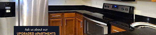 Spacious kitchen with granite countertops, stainless steel appliances and custom home cabinetry.