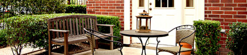 Private backyard patios and red brick exteriors at Tuscany Villas in Houston.