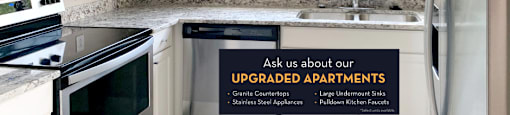 Luxury apartments with granite countertops, white cabinets, stainless steel appliances, and side-by-side refrigerator at Saddlebrook apartments in Urbandale Iowa